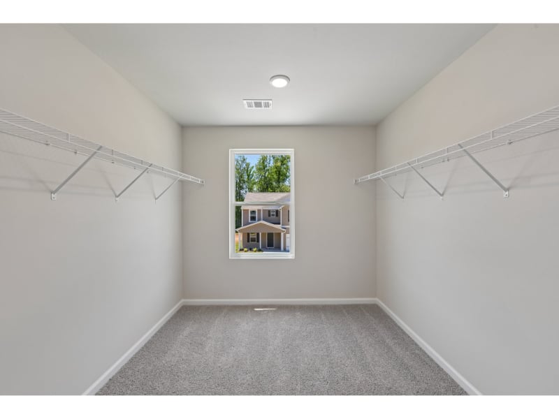 A room with a window and a staircase.