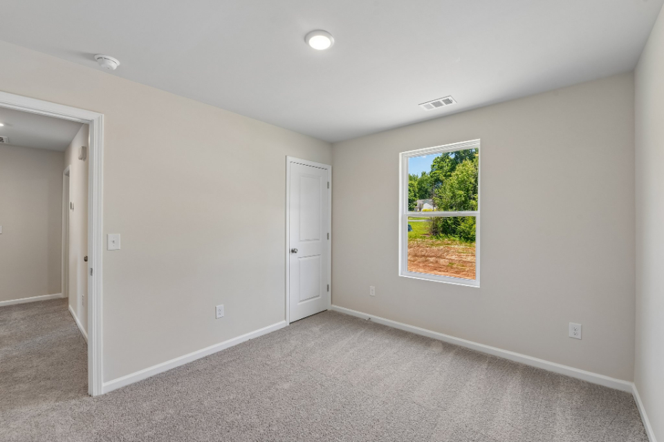 A room with a window and a door.