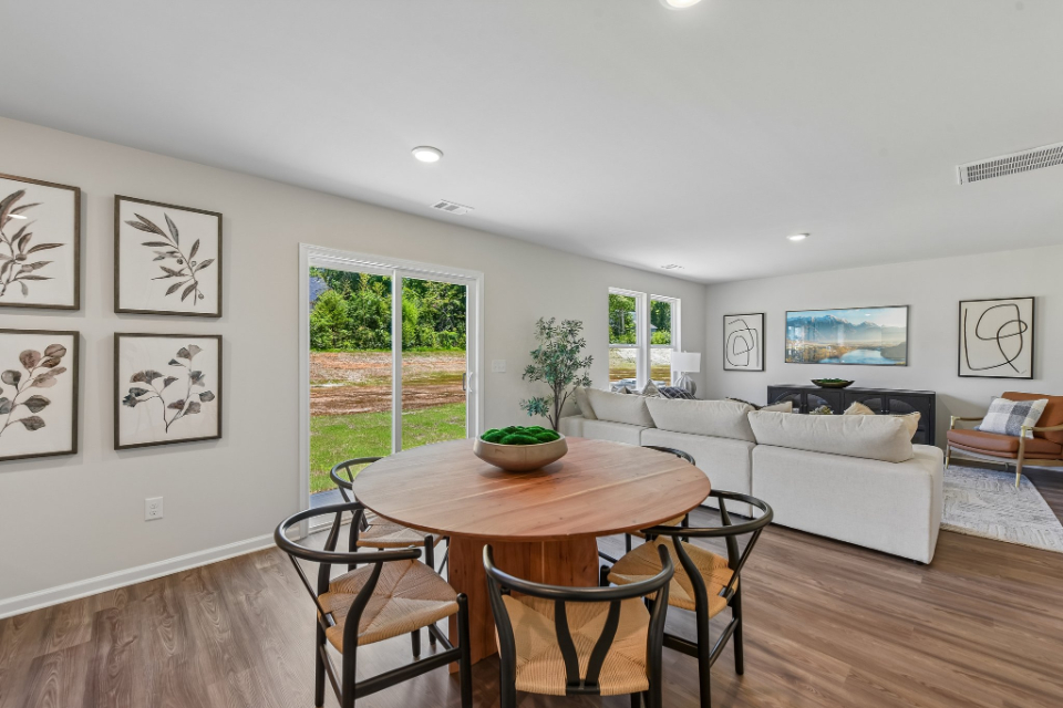 A living room with a table and chairs.