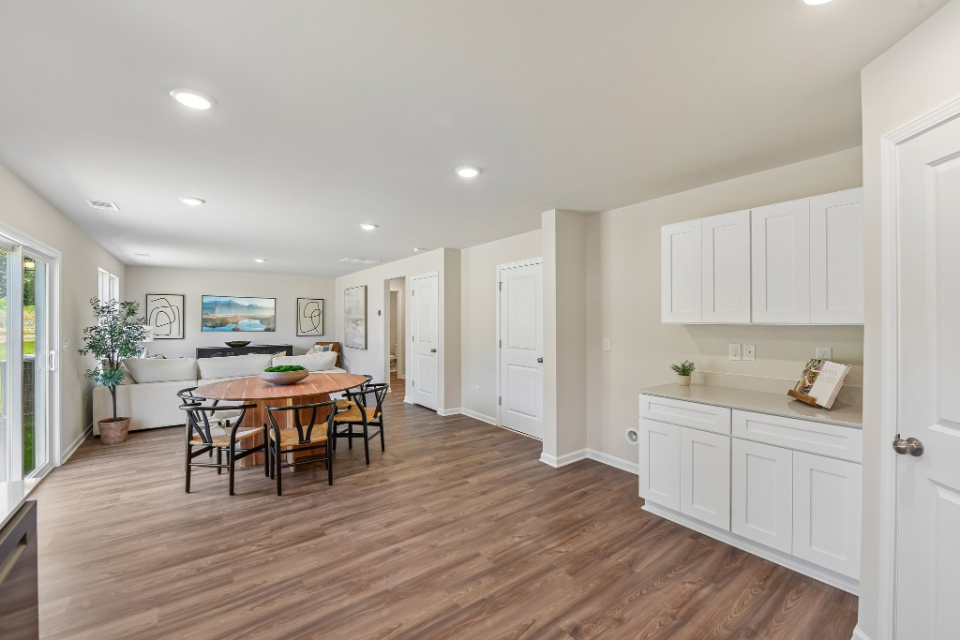 A large kitchen with a dining table.
