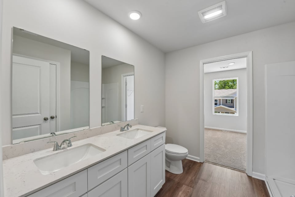 A bathroom with a large mirror.