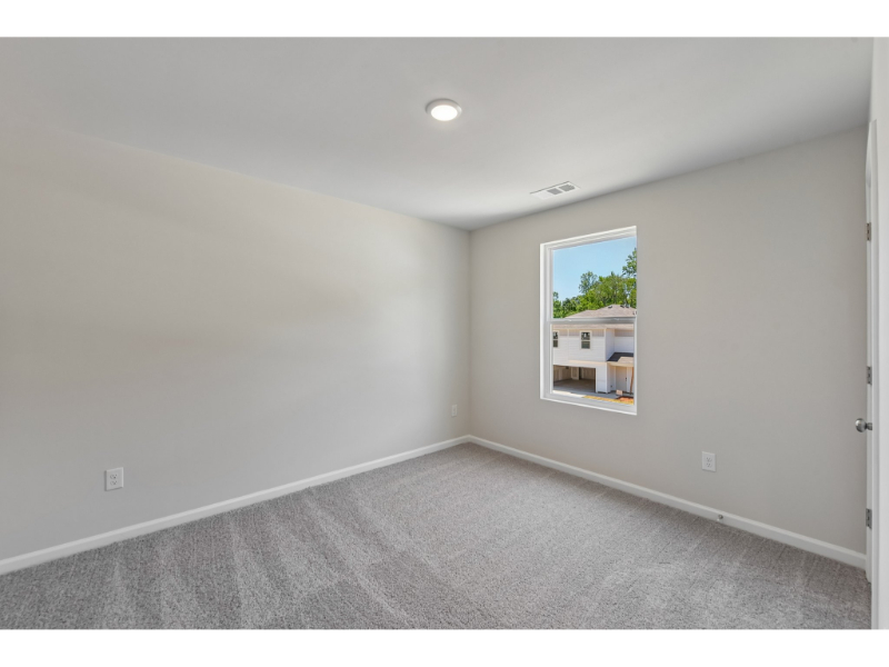 A room with a window and a door.
