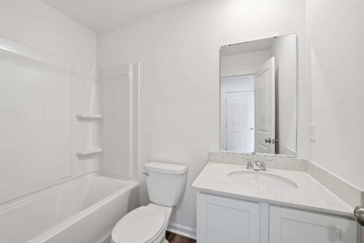 A bathroom with a sink toilet and bathtub.