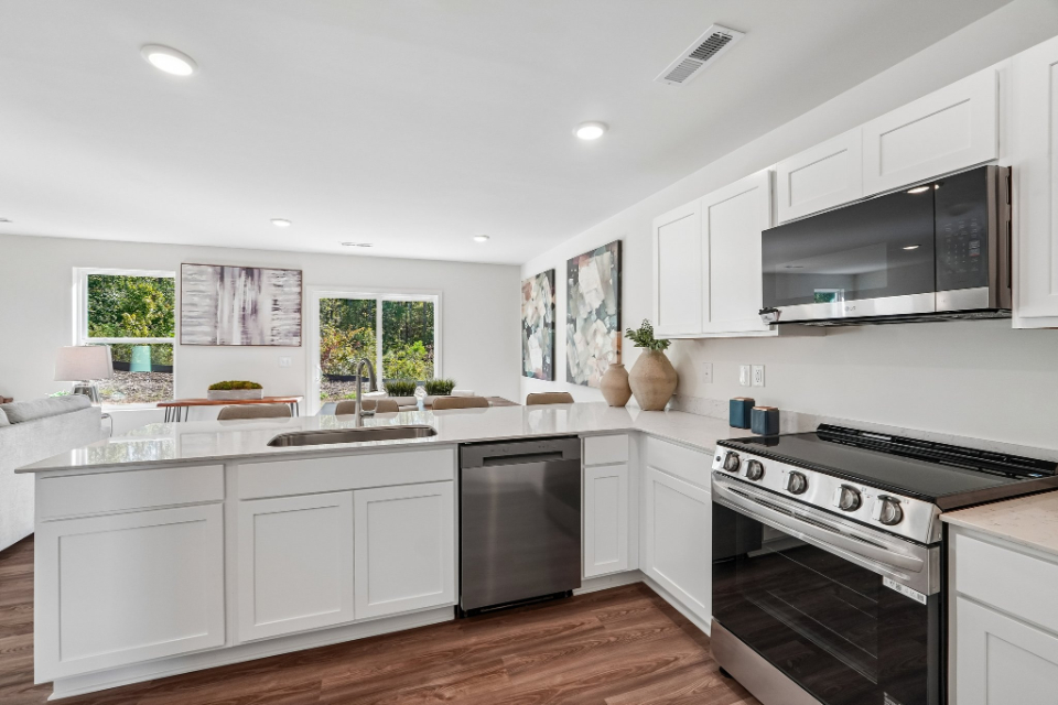 A kitchen with white cabinets.