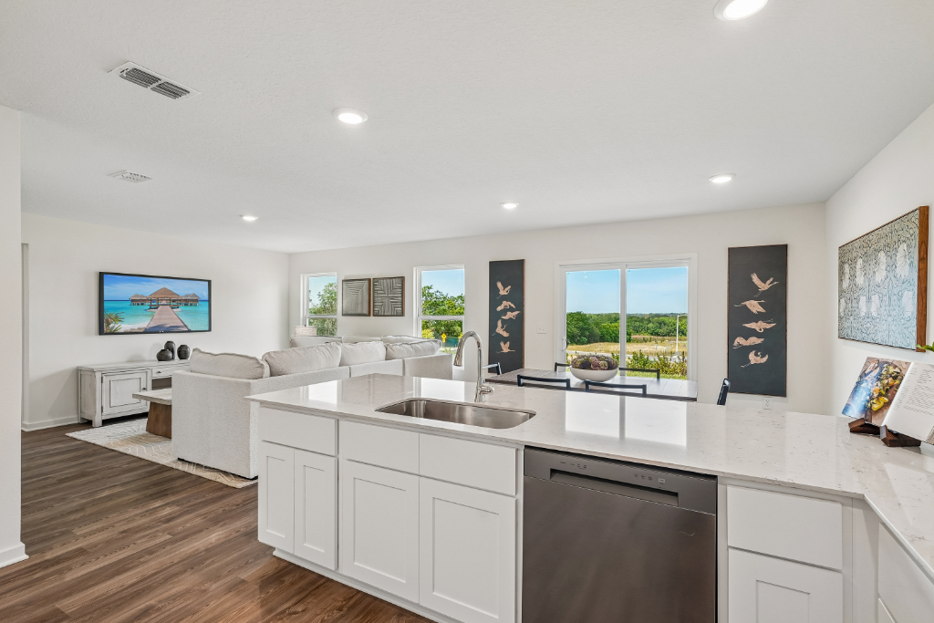 A kitchen with white cabinets.