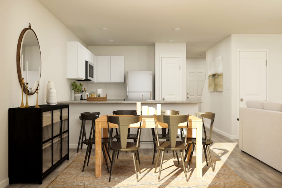 A kitchen with a dining table.
