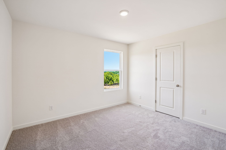 A room with a door and a window.