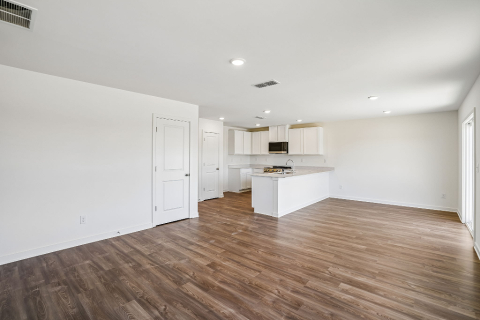 A room with white walls and a wood floor.