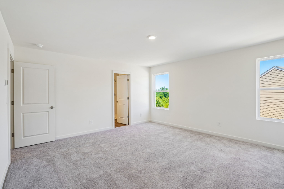 A room with white walls and a window.