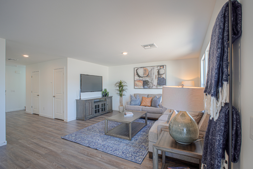 A living room with a rug and a tv.