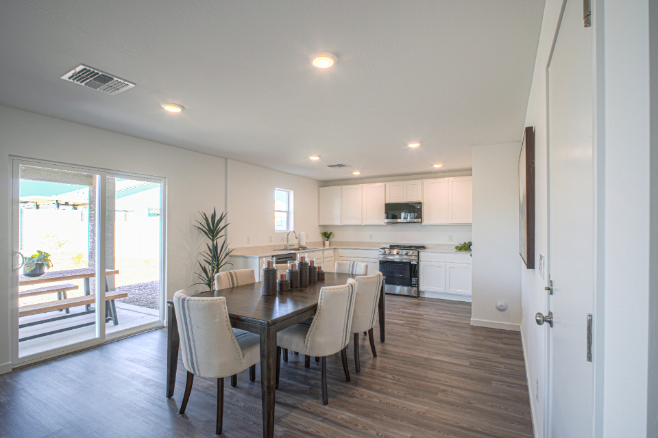 A kitchen with a dining table.