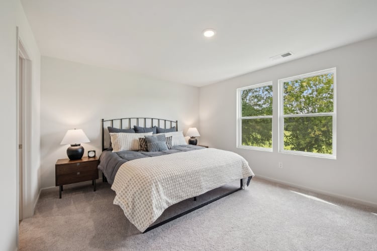 A bedroom with a bed and a window.