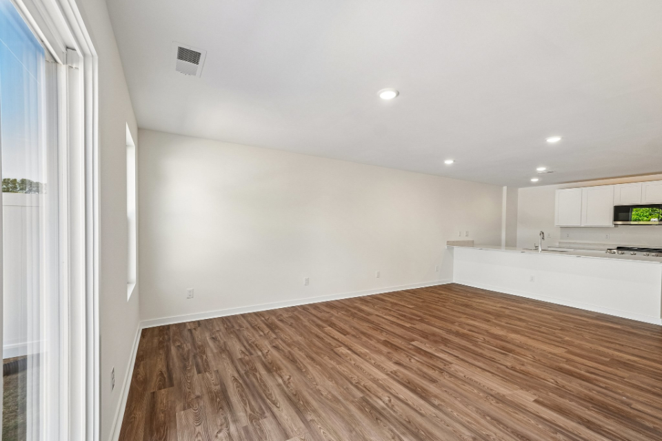 A room with a wood floor and white walls.