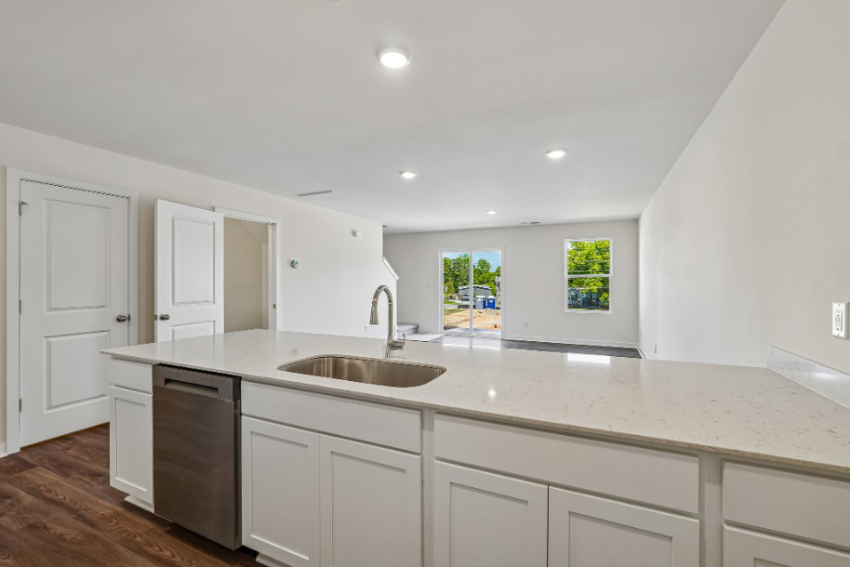 A kitchen with white cabinets.