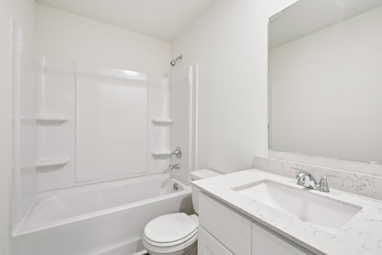 A bathroom with a sink toilet and bathtub.