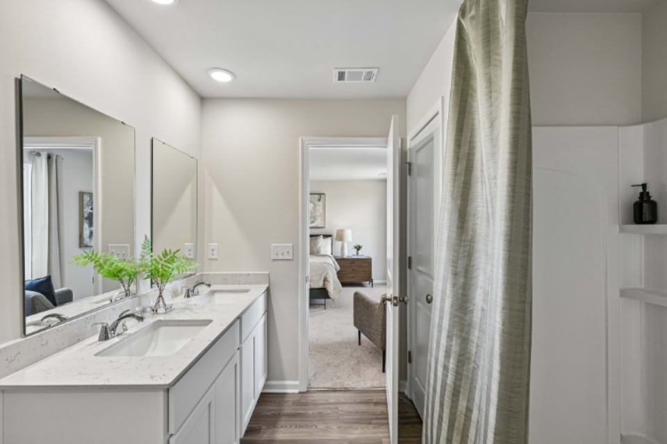 A bathroom with a sink and a bed.