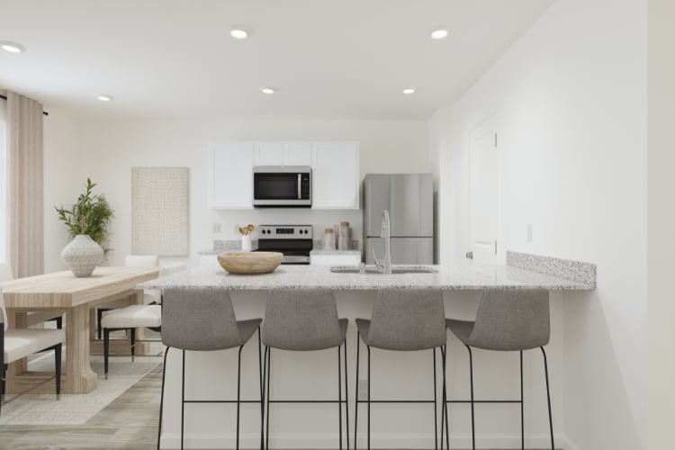 A kitchen with a table and chairs.