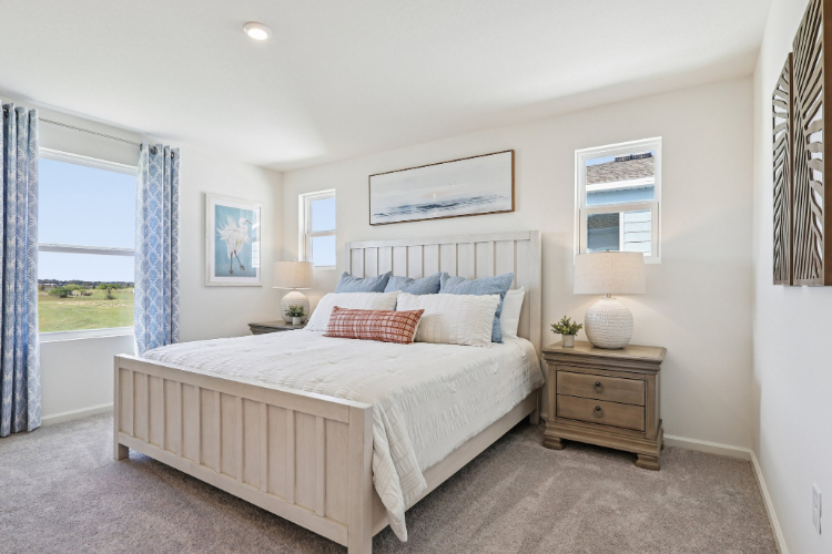 A bedroom with a large window.