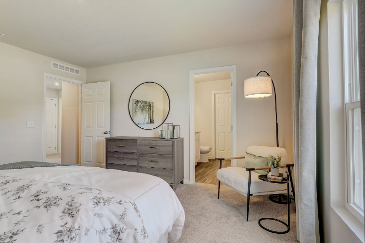 A bedroom with a bed and a table.