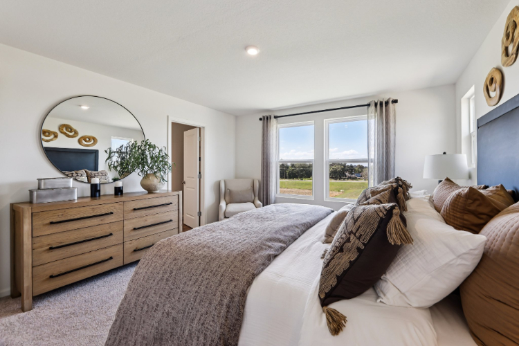 A bedroom with a bed and a dresser.