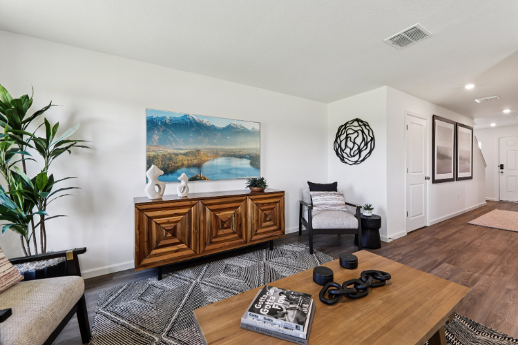 A living room with a large painting.