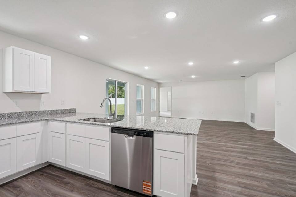 A kitchen with white cabinets.