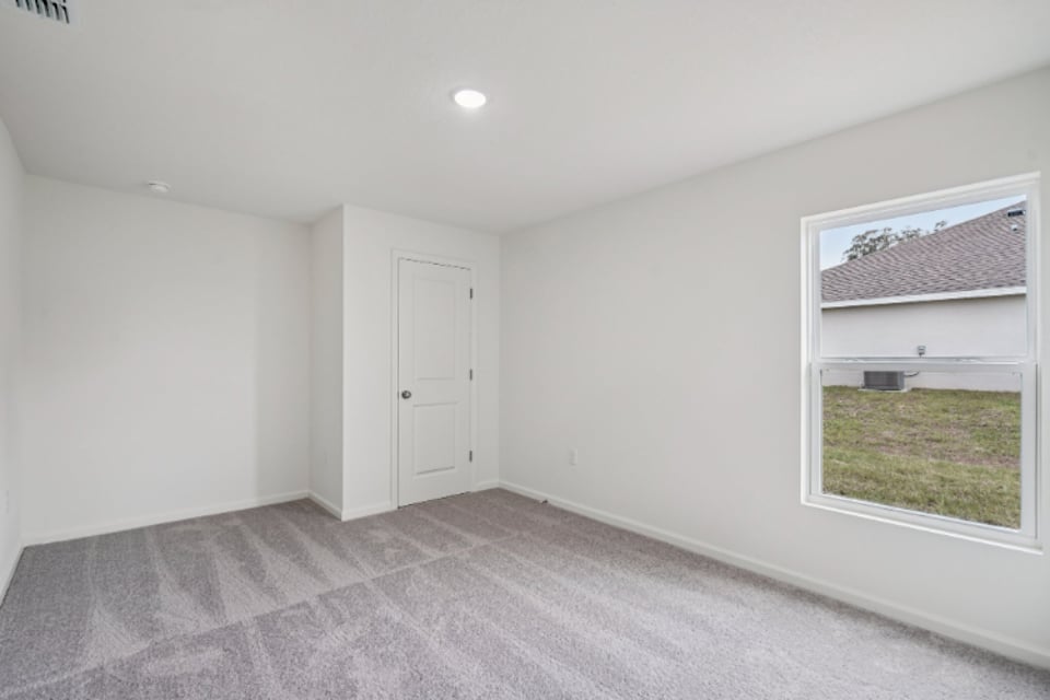 A room with a window and a door.