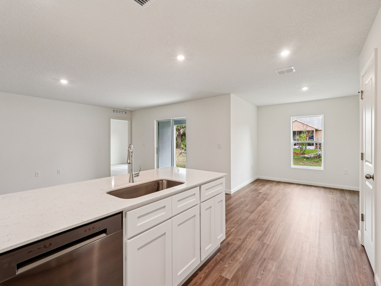 A kitchen with white cabinets.