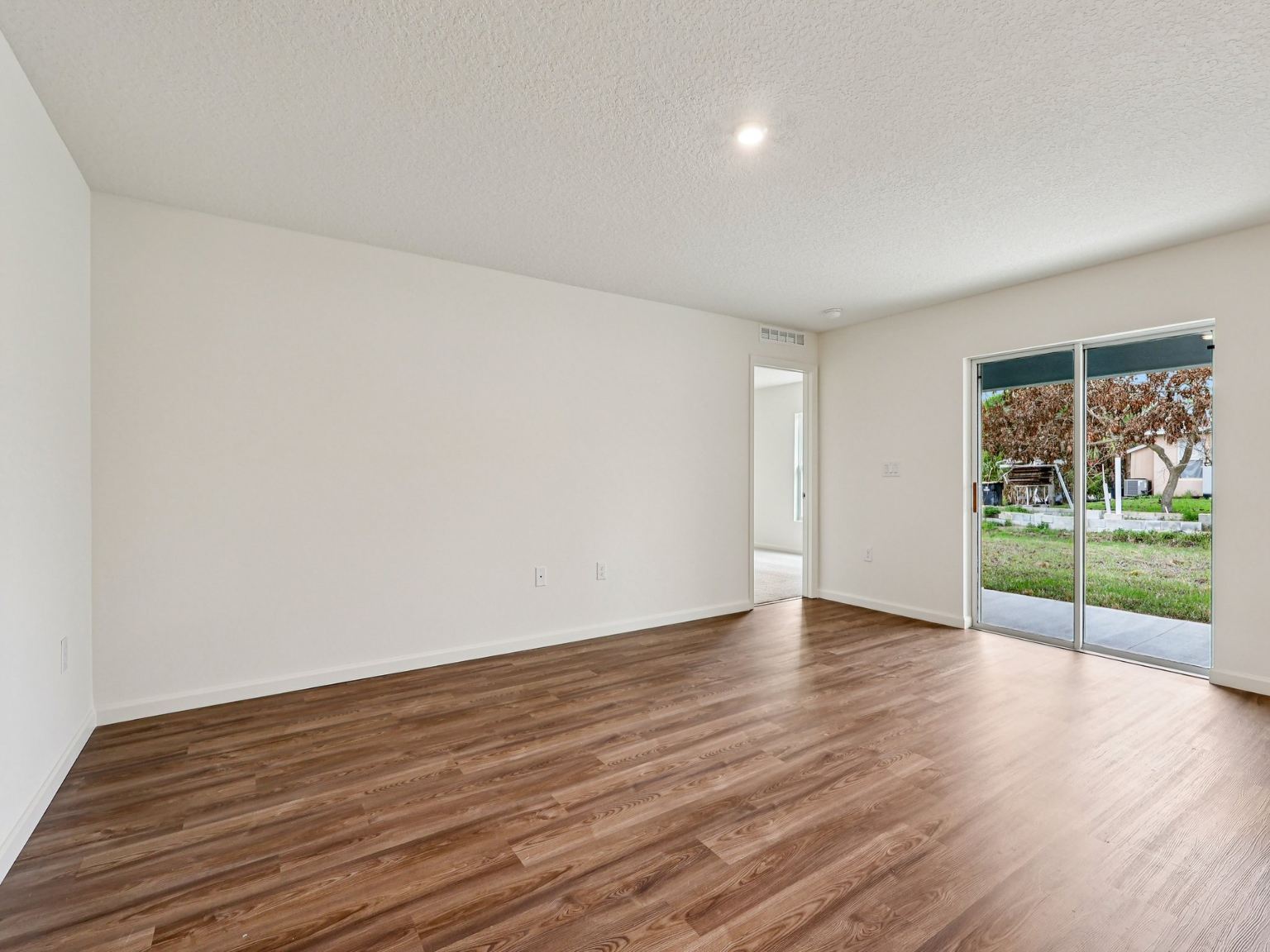 A room with a wood floor and a wood floor.