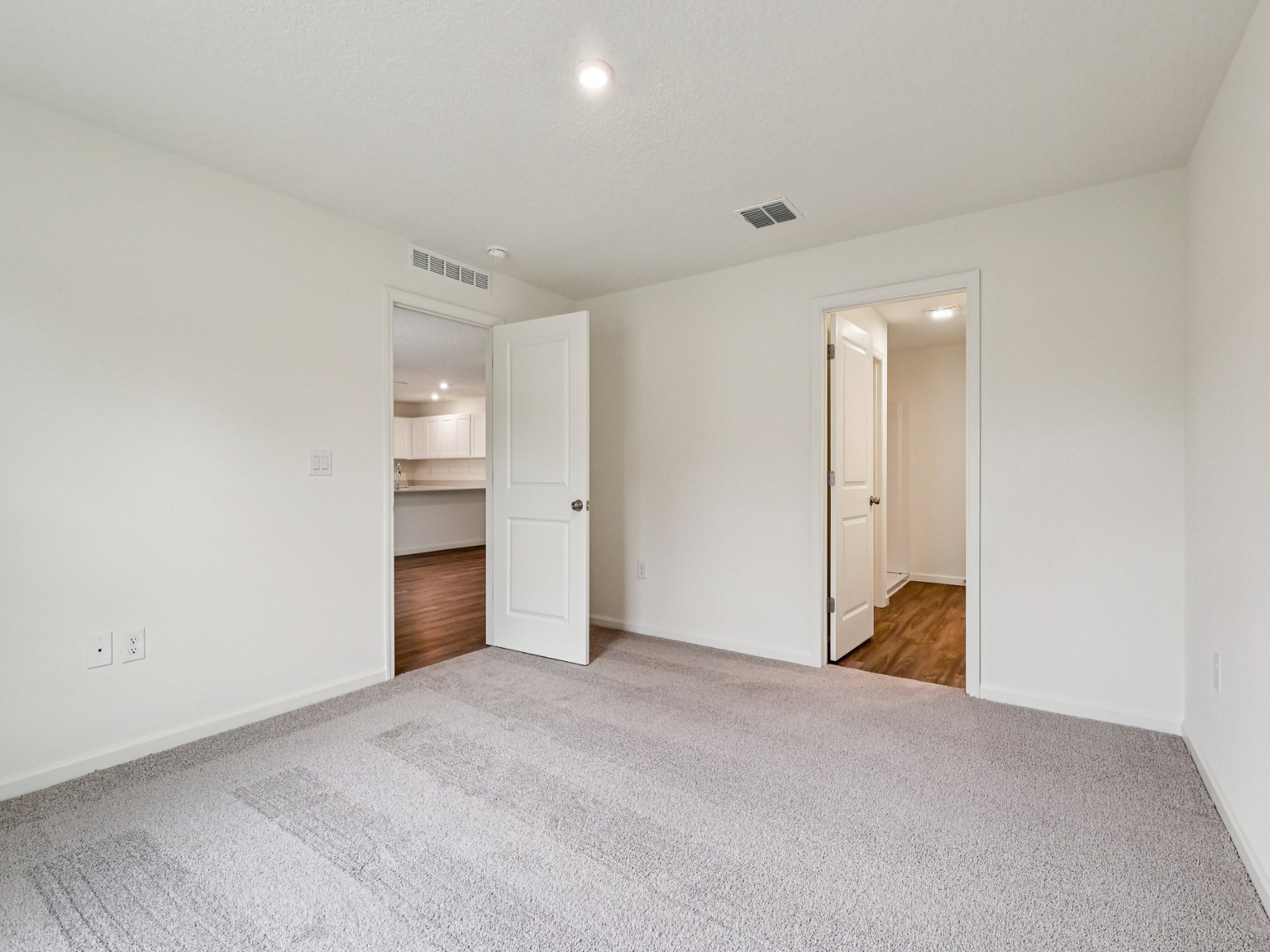A hallway with white walls.