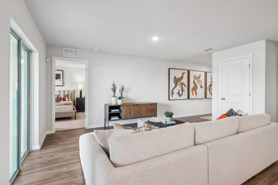 A living room with a couch and a table.
