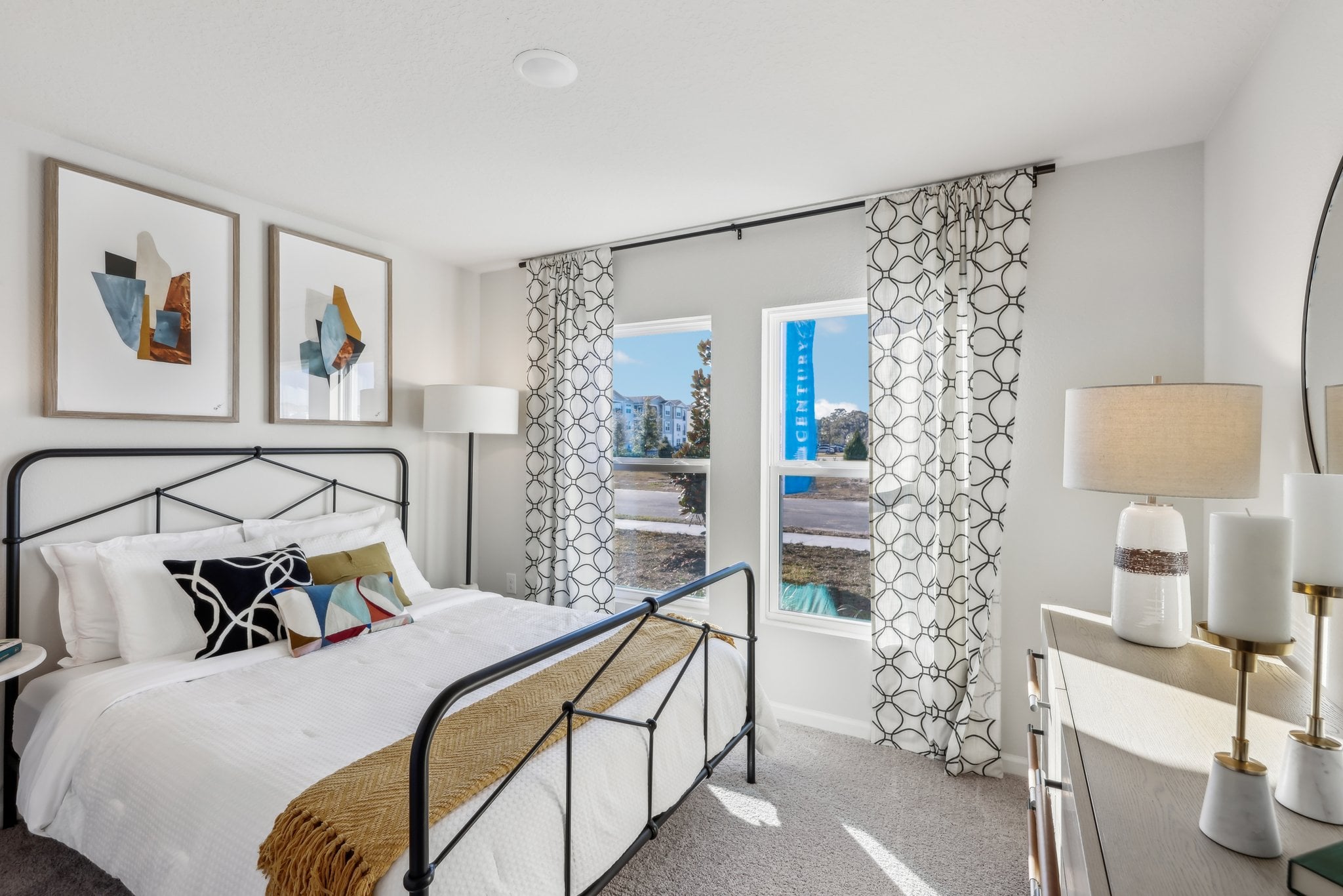 A bedroom with a bed and lamps.