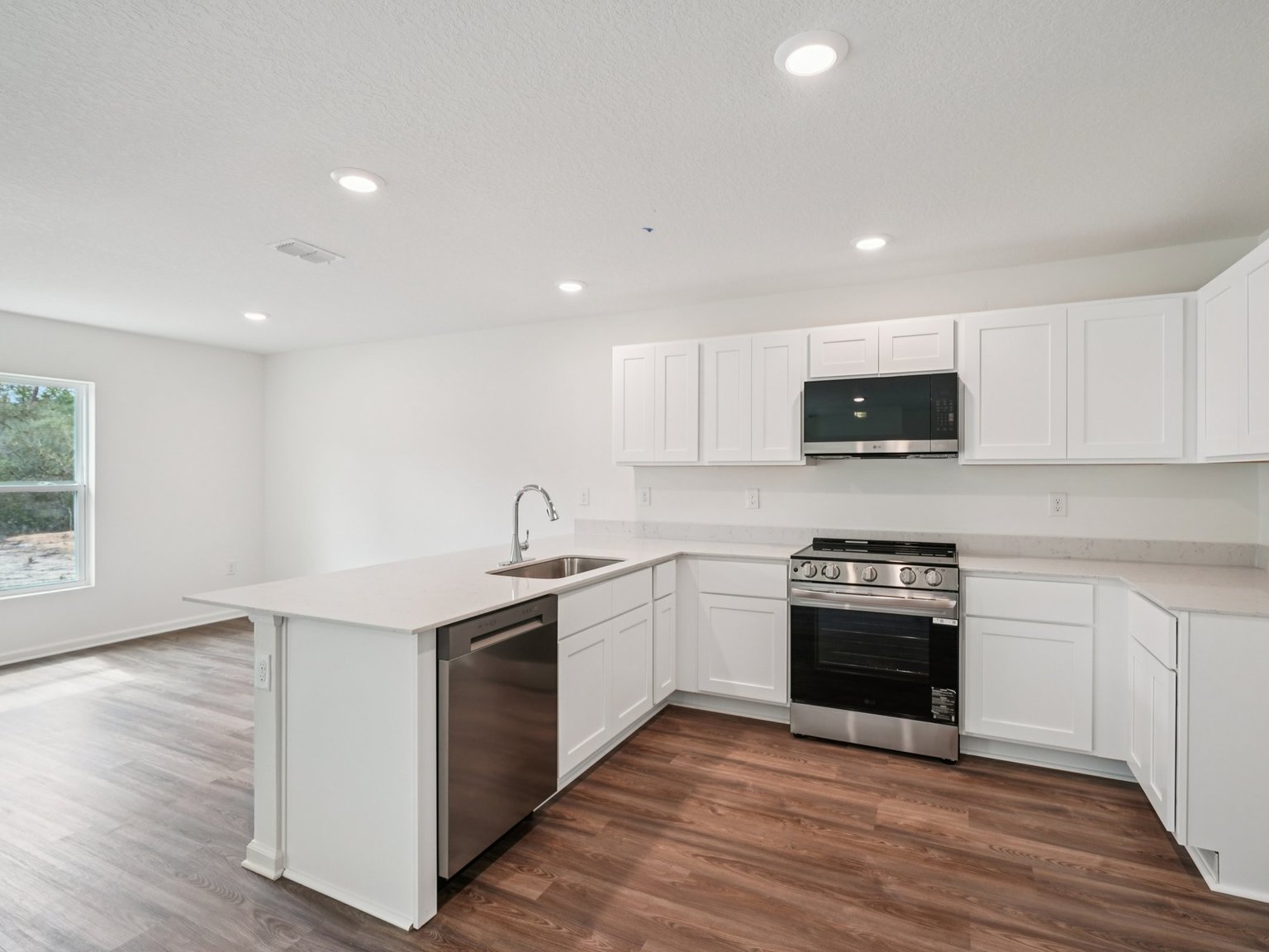 A kitchen with white cabinets.