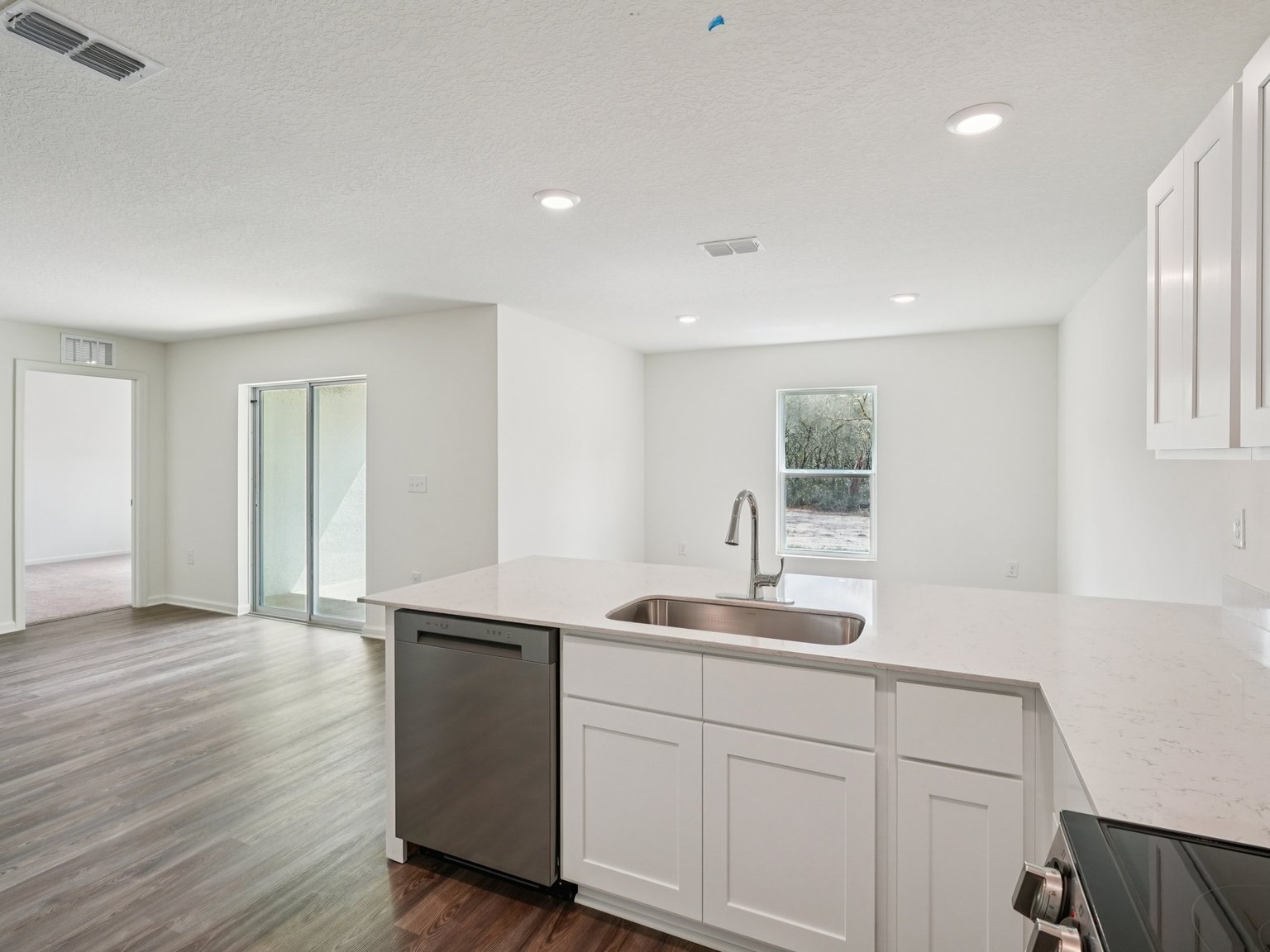 A kitchen with white cabinets.