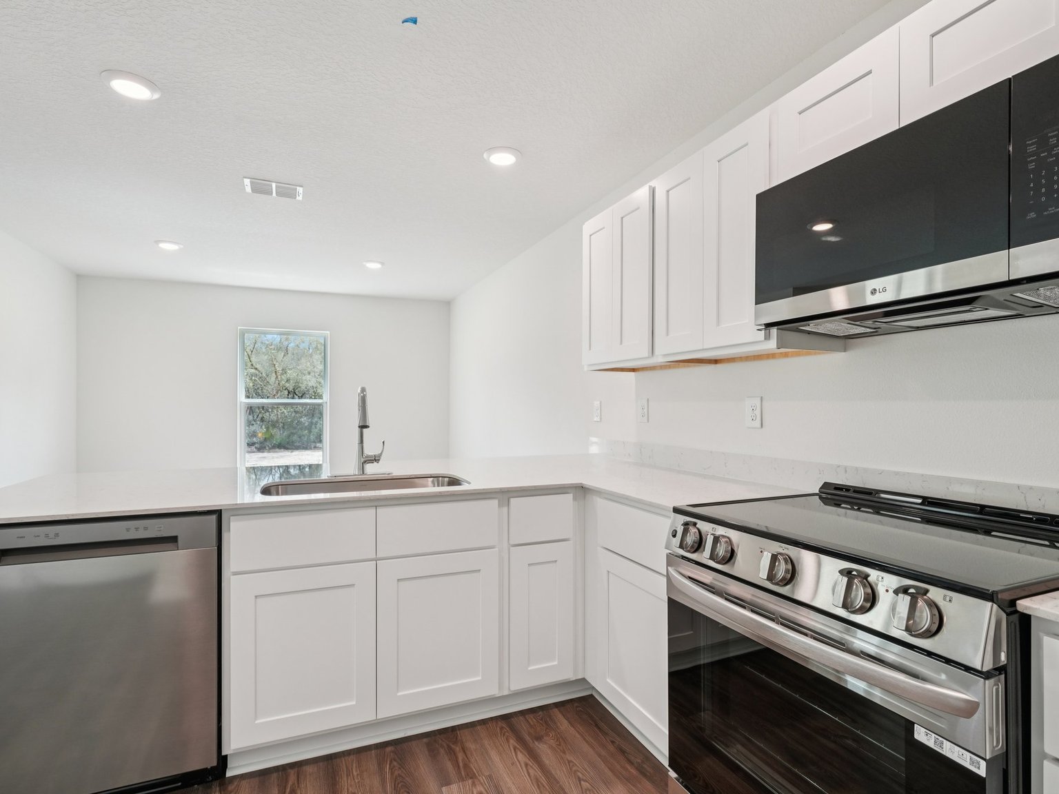 A kitchen with white cabinets.
