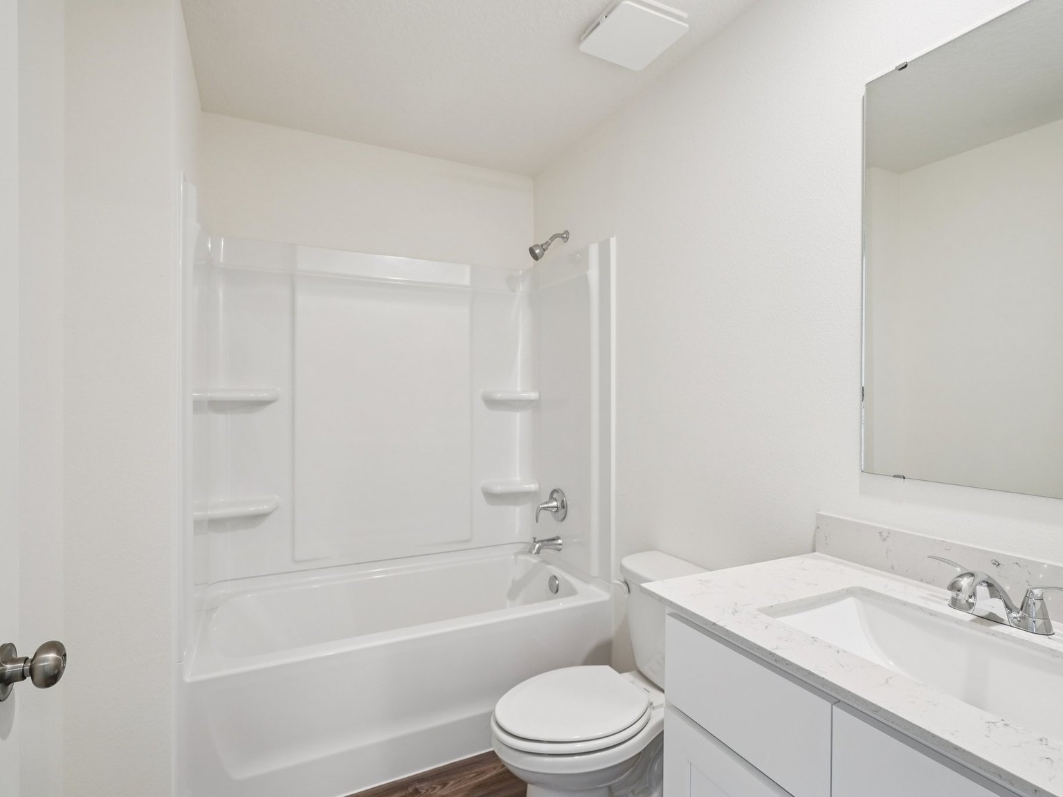 A bathroom with a tub sink and toilet.