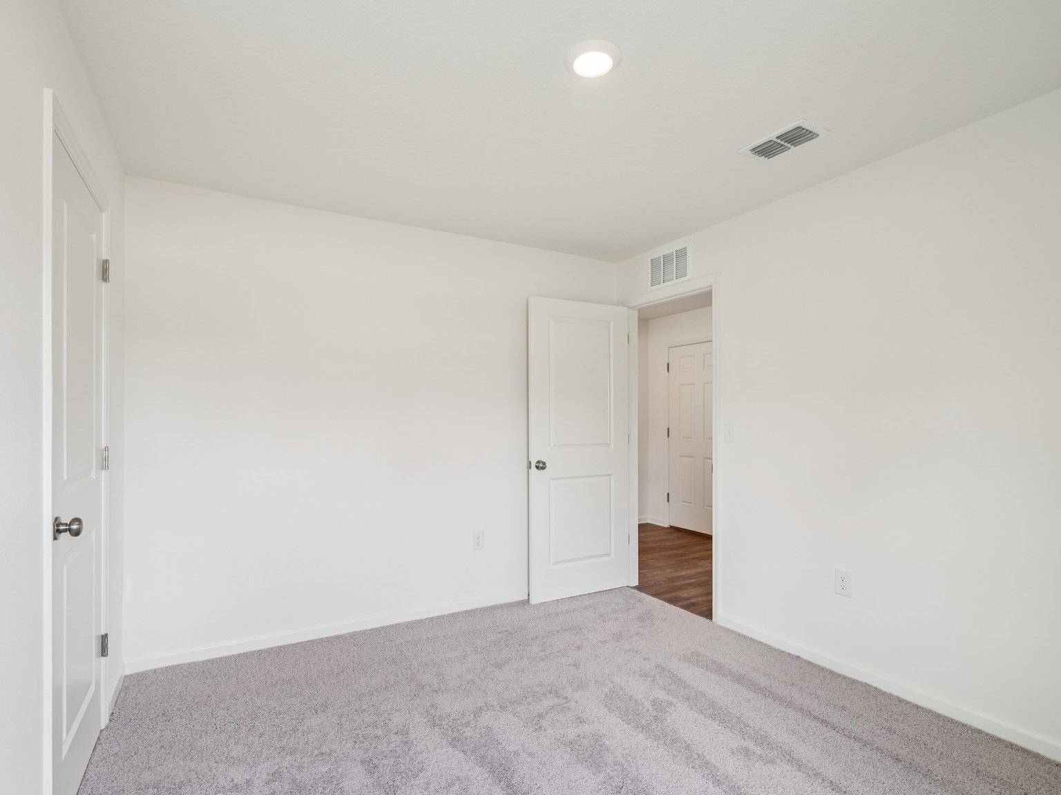 A hallway with white doors.