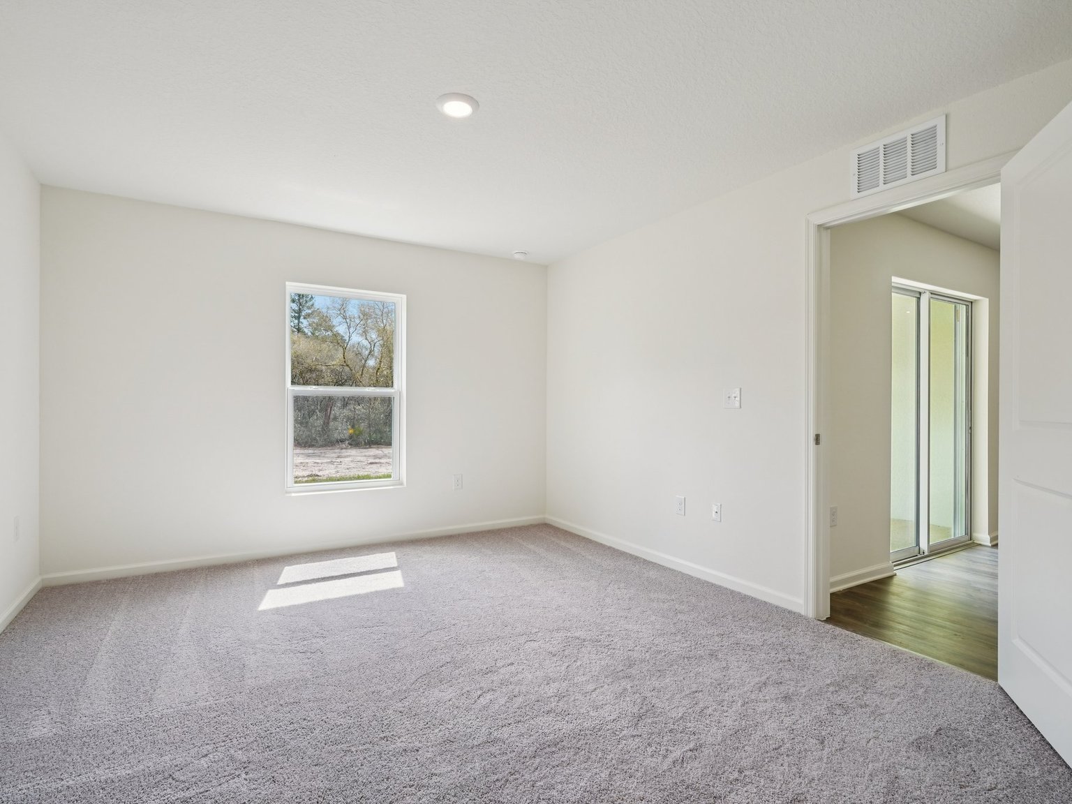 A hallway with white walls.