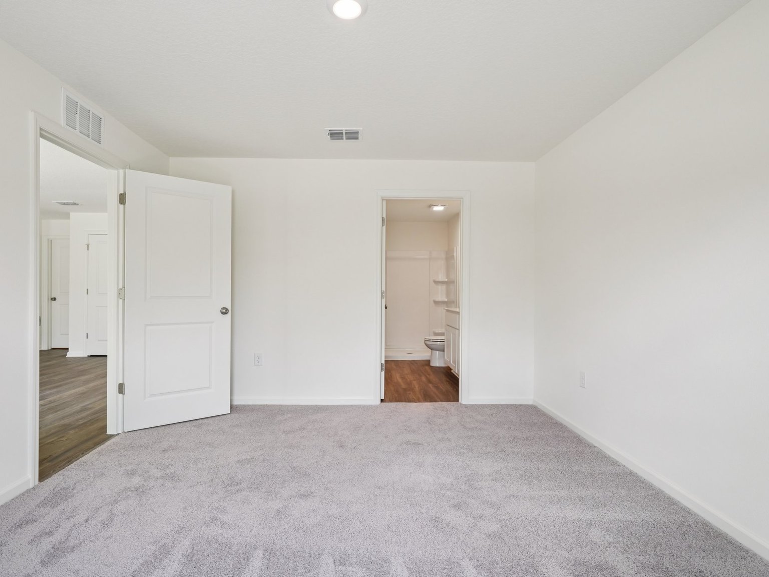 A hallway with white doors.
