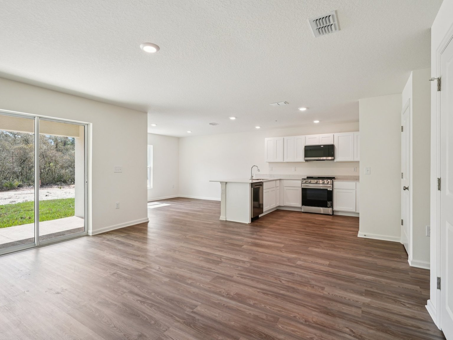 A large kitchen with white cabinets.