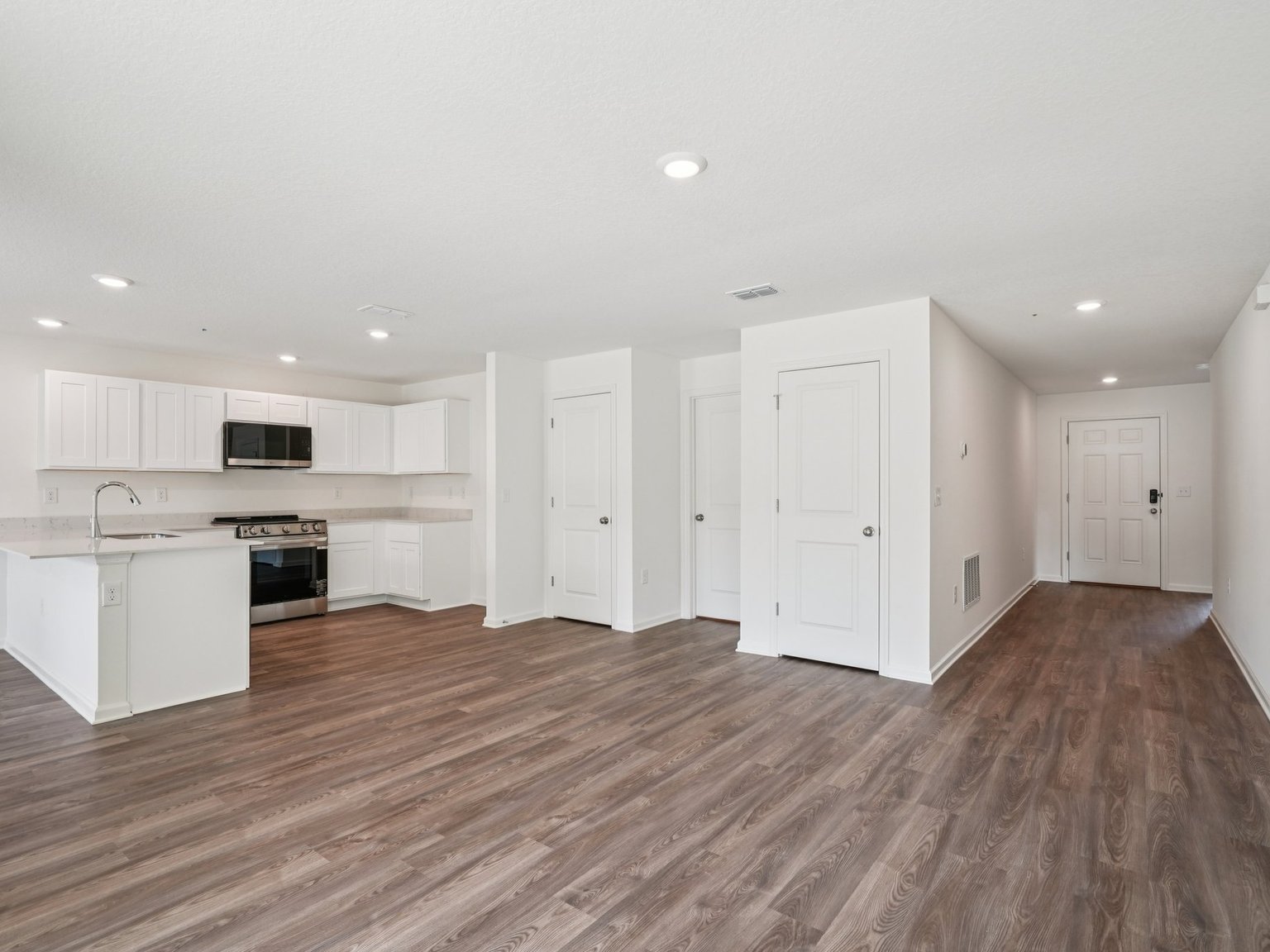 A large kitchen with white cabinets.