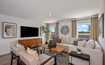 A living room with a couch and a tv.