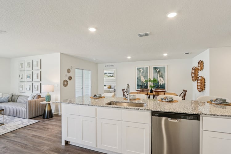 A kitchen with white cabinets.