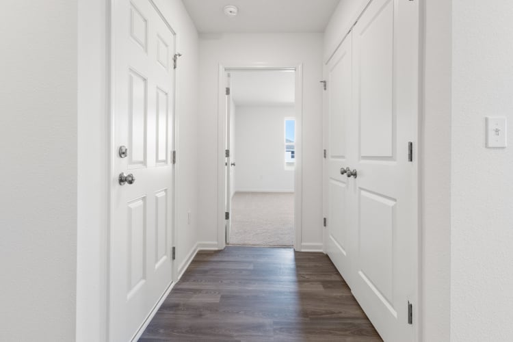 A hallway with white doors.