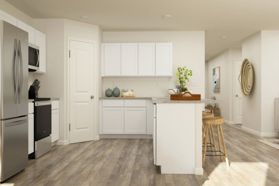 A kitchen with white cabinets.