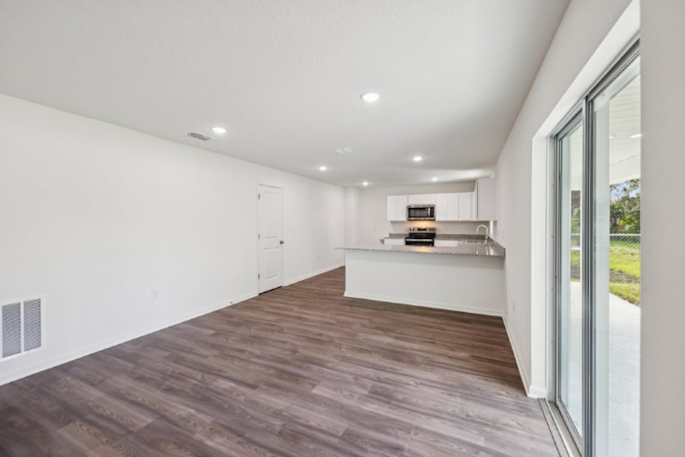 A room with a wood floor and white walls.