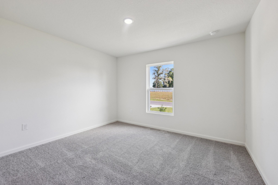 A room with a carpet and a painting on the wall.
