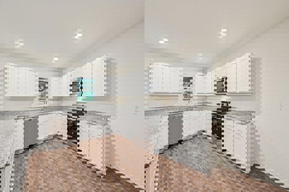 A kitchen with white cabinets.