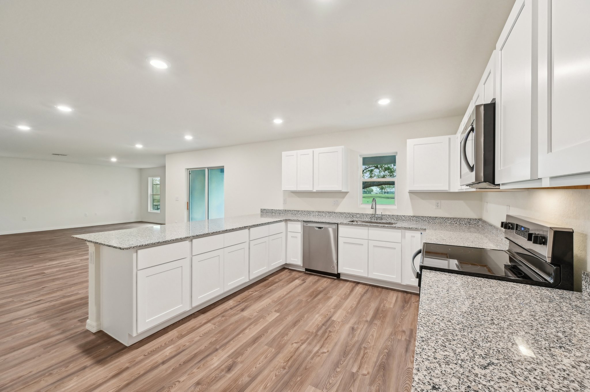 A kitchen with white cabinets.