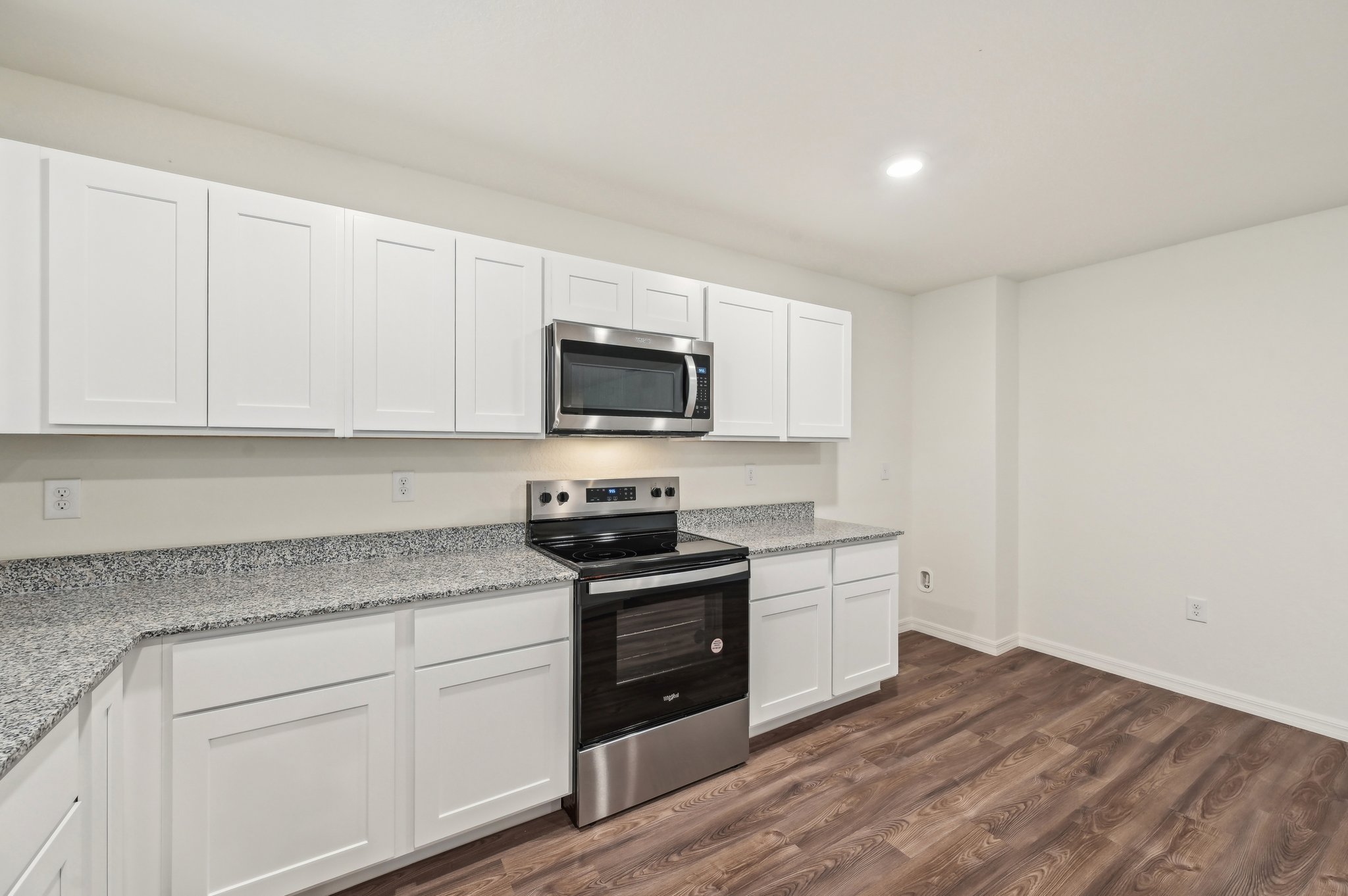 A kitchen with white cabinets.
